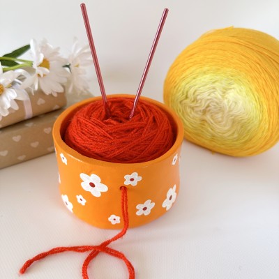 Small orange crochet yarn holder bowl with retro daisy flowers Knitter gifts