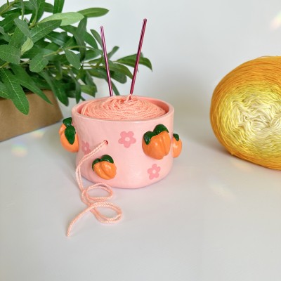 Small crochet yarn bowl with peach and daisy flowers and daisy flowers