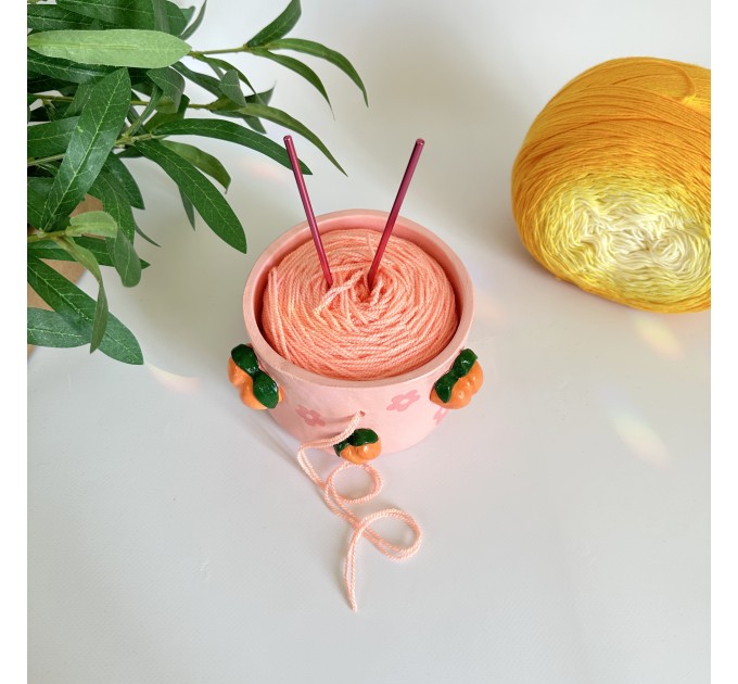 Small crochet yarn bowl with peach and daisy flowers and daisy flowers