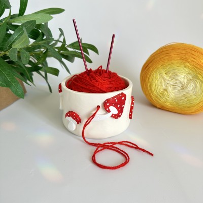 Small milky crochet yarn bowl with amanita mushrooms