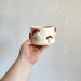 Small milky crochet yarn bowl with amanita mushrooms